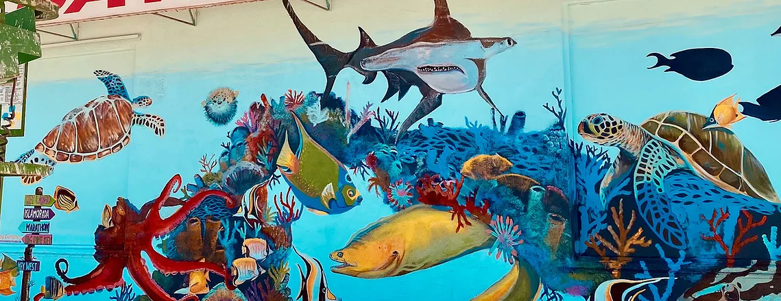Large outdoor mural with coral reef and sea life