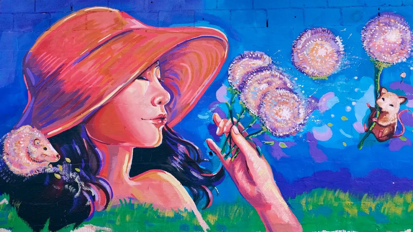 Mural, mujer y dientes de león